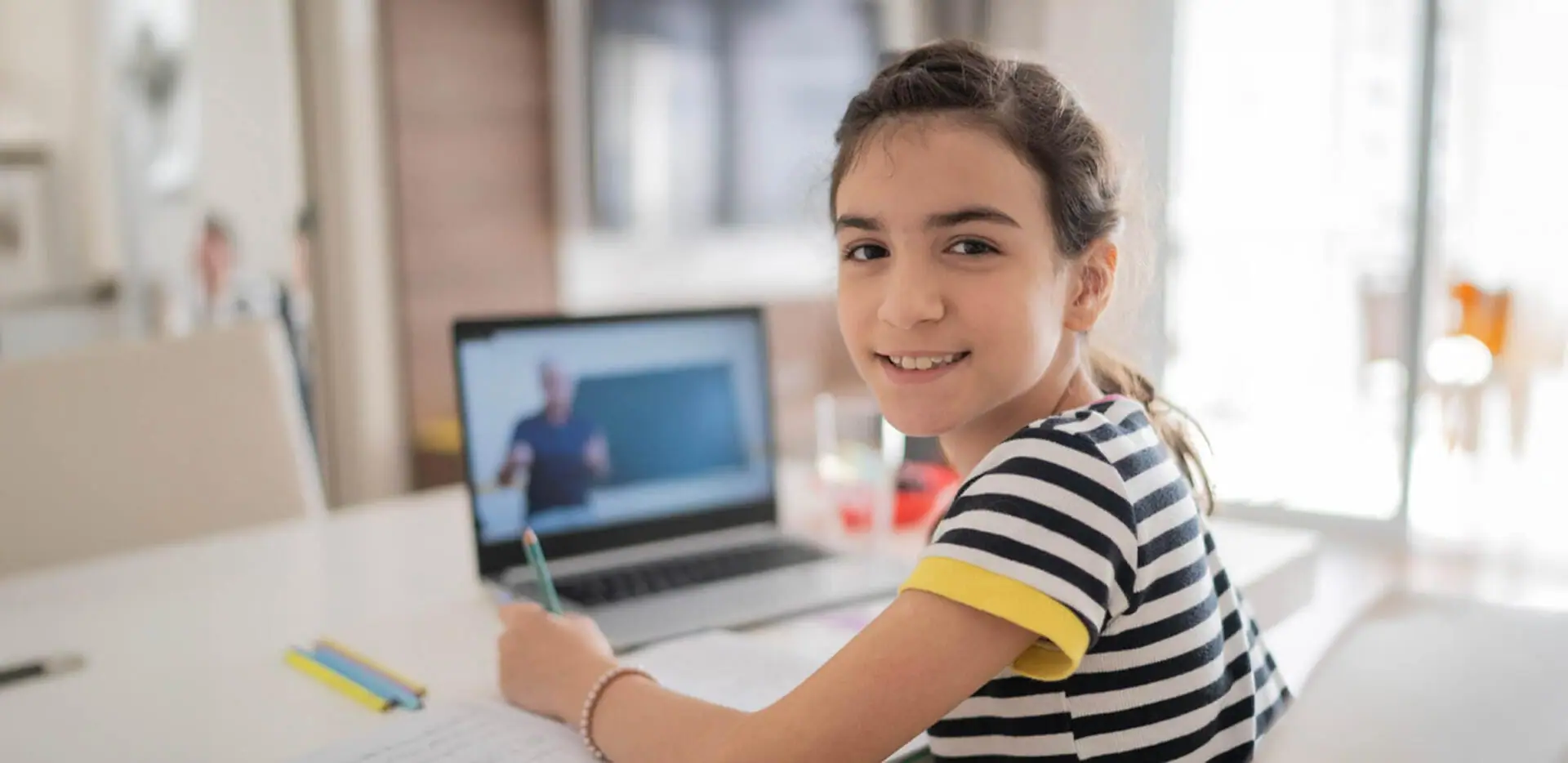 Student attending to an online class wearing a stripped shirt